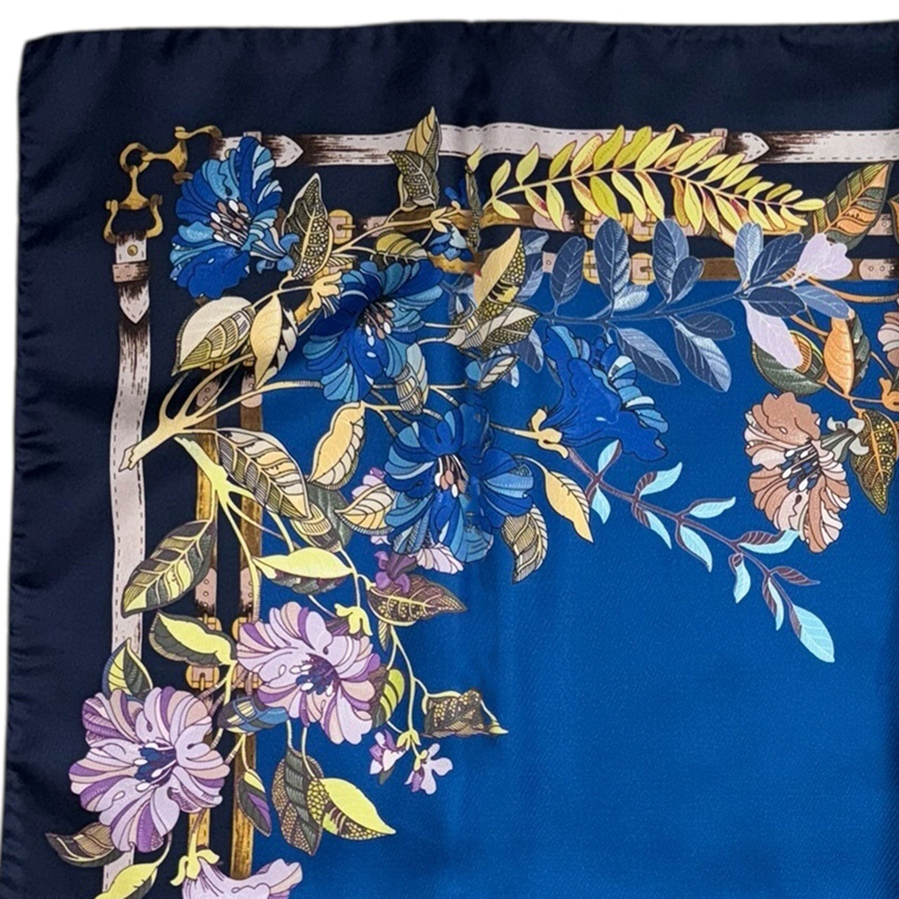 Laura Biagiotti scarf with floral and belt design on a blue background