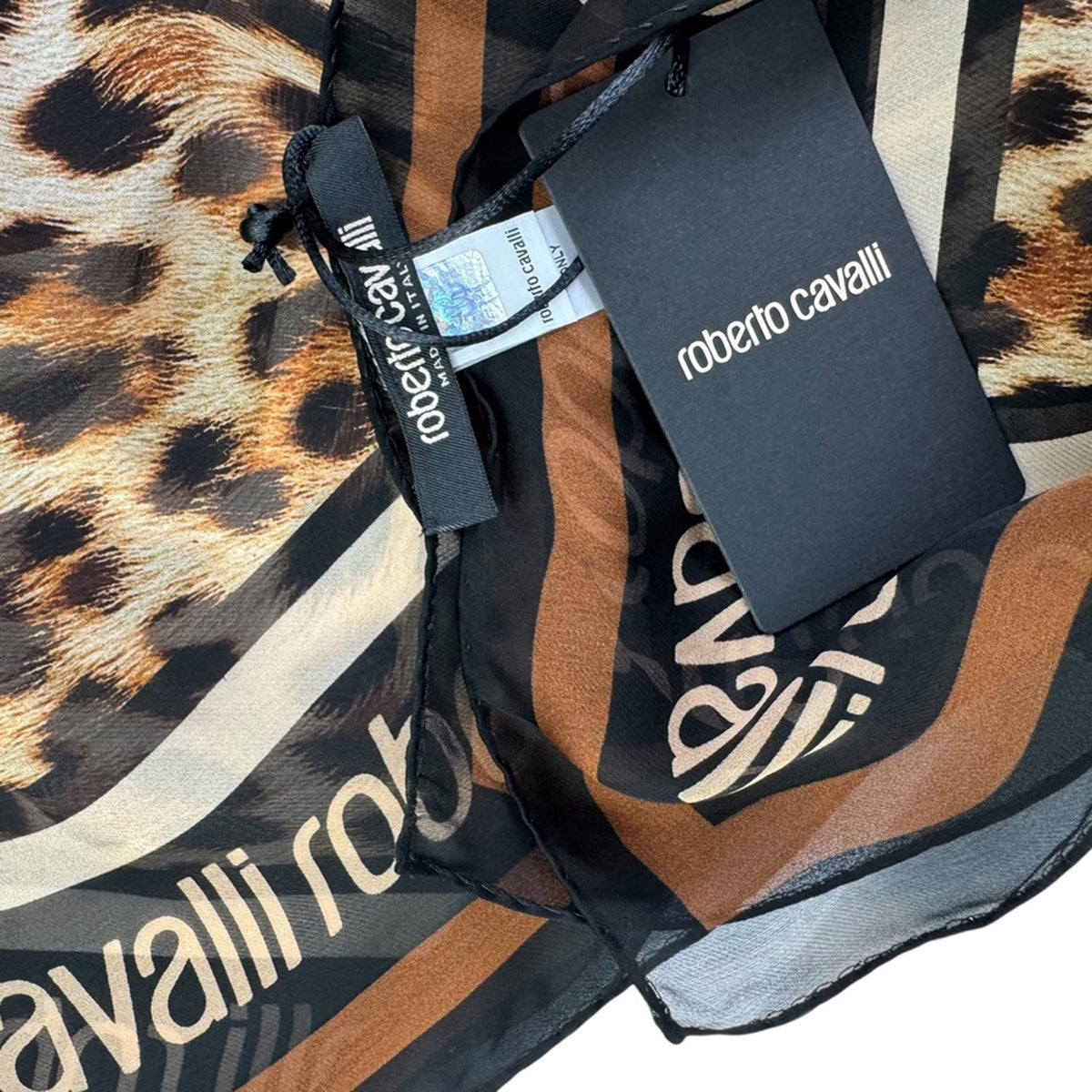 Roberto Cavalli bag with leopard print pattern and brand tags.